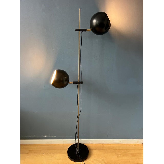 Classic mid century floor lamp with two black eyeball shades. The two metal shades can be turned in any direction. They...