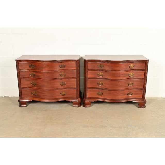 An exceptional pair of Georgian or Chippendale style serpentine front dressers or chests of drawers By Baker Furniture,...