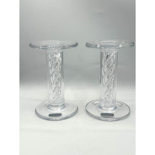 Retired pair of Simon Pearce Stratton single-light candlesticks, expertly hand-blown in lead-free crystal with the...