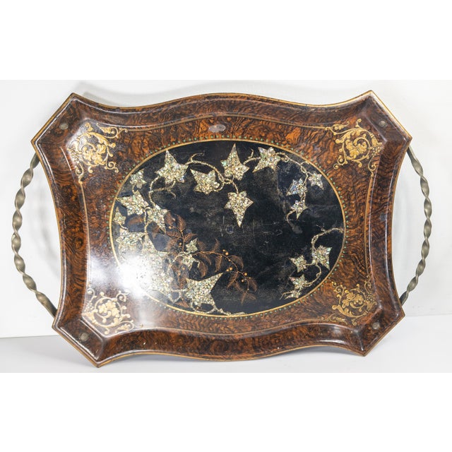 We are selling this very pretty English metal serving tray. This tray has faux wood grain painted border with a central...