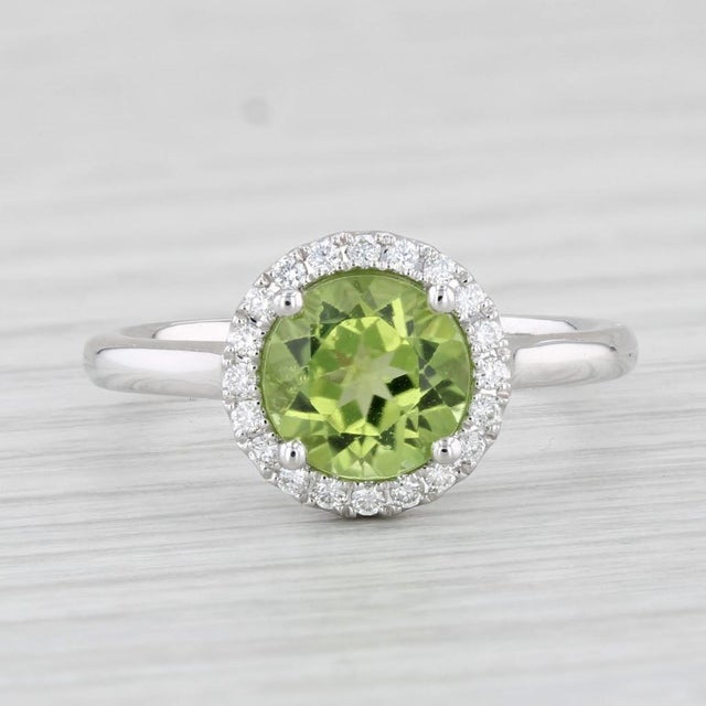 Gemstone Information: - Natural Peridot - Carats - 1.48ct Cut - Round Brilliant Color - Green - Natural Diamonds - Total...