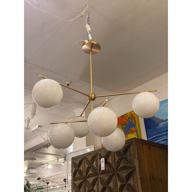 Design Plus Gallery presents the Sphere + Stem Chandelier from West Elm. This modern six-light fixture has a brass-toned...