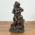 A Greco-Roman inspired vintage bronze fountain from the mid 20th century, depicting a putto riding a dolphin. Created with...