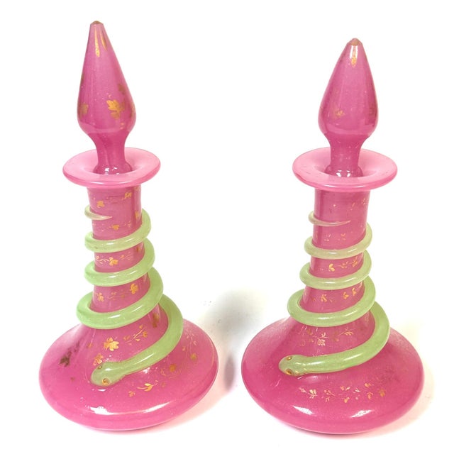 Pair of French Pink Opaline Perfume Bottles with Applied Green Serpents Attributed to Baccarat A striking and highly...