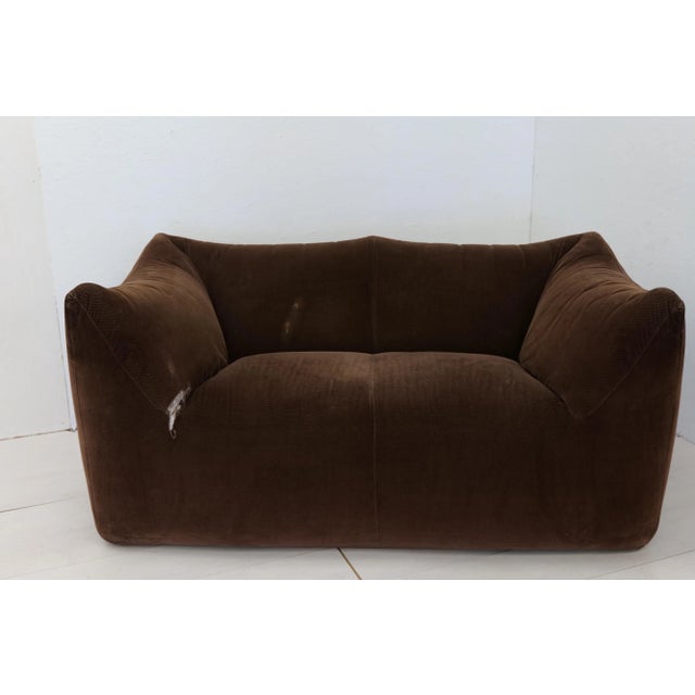This comfortable brown original fabric settee is bulky and playful, shaped as if it is merely a large cushion and the...