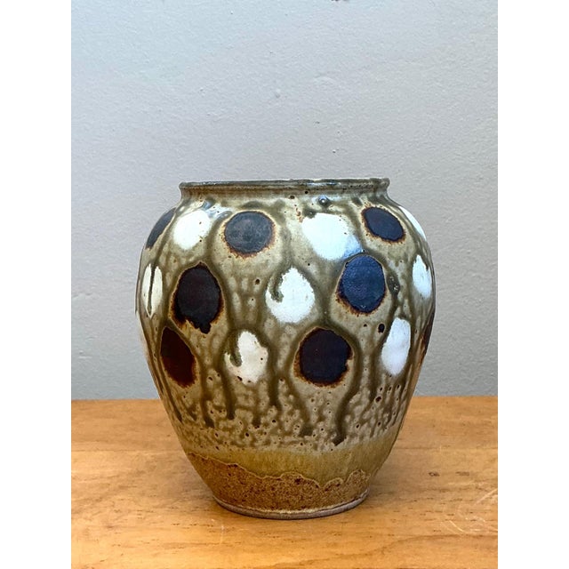This vintage handcrafted ceramic vase is a striking example of mid-20th-century artisanal stoneware, celebrating organic...