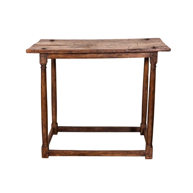 Neoclassical walnut table. Colonette legs joined by stretcher base.