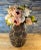 This 12-inch tall ceramic vase is designed in the shape of a tortoise shell and has a narrow profile. The vase's surface...