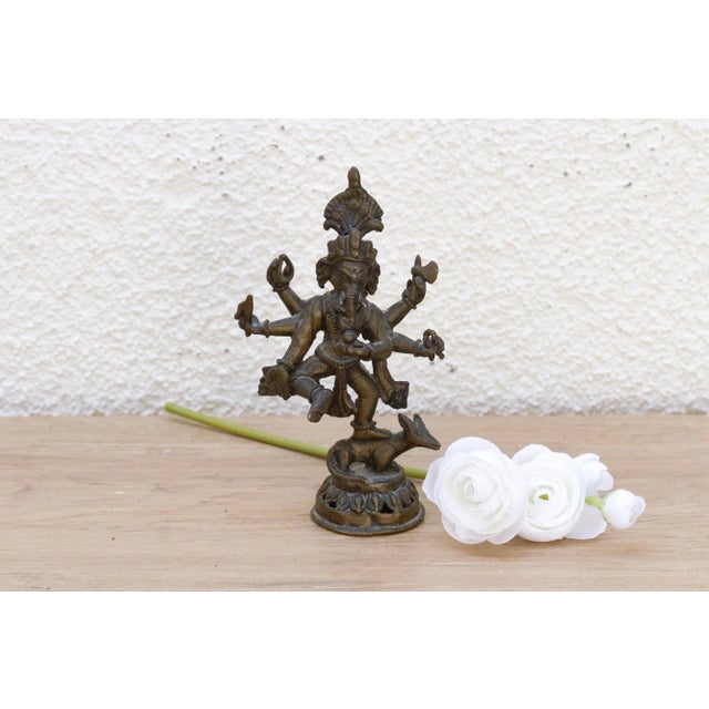 This small antique brass statue is a beautiful testament to a rich spiritual tradition. Likely of Indian origin and dating...