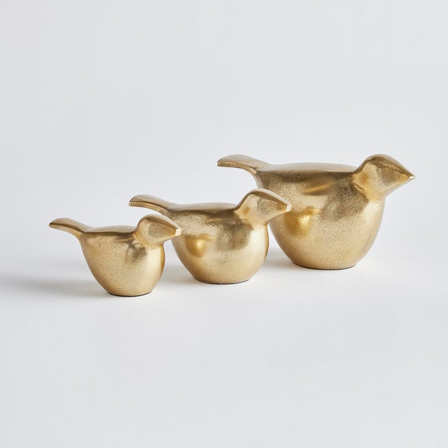 This trio of modern bird sculptures is made of cast aluminum and finished in a warm gold. A charming accent for ottoman,...