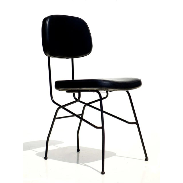 This pair of chairs features a black metal frame with black skai seating.