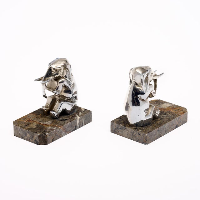 Bookends from France made with gray marble bases and showcasing silver plated elephant sculptures. They are in very nice...