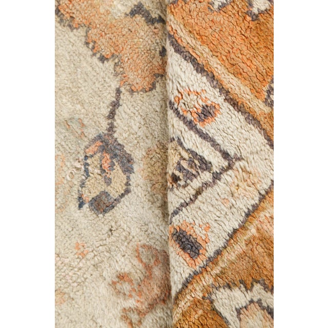 This early 20th-century Turkish Oushak rug is a masterful embodiment of Anatolian weaving traditions, distinguished by its...