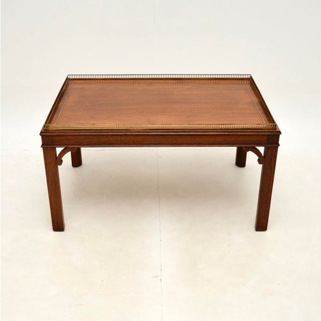 A wonderful antique inlaid brass Chippendale style coffee table, made in England and dating from around the 1930’s. This...