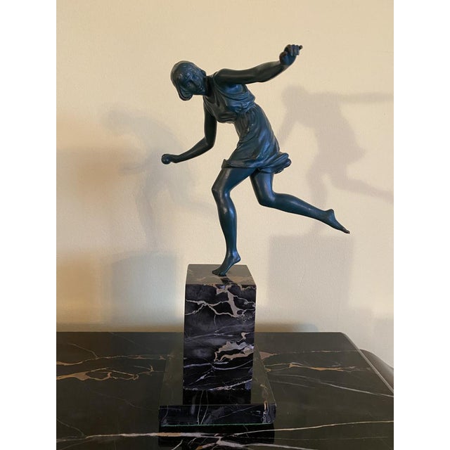 A French Art Deco bronze sculpture of a young girl with a ball. The bronze maintains it's original green patina and stands...