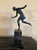 A French Art Deco bronze sculpture of a young girl with a ball. The bronze maintains it's original green patina and stands...