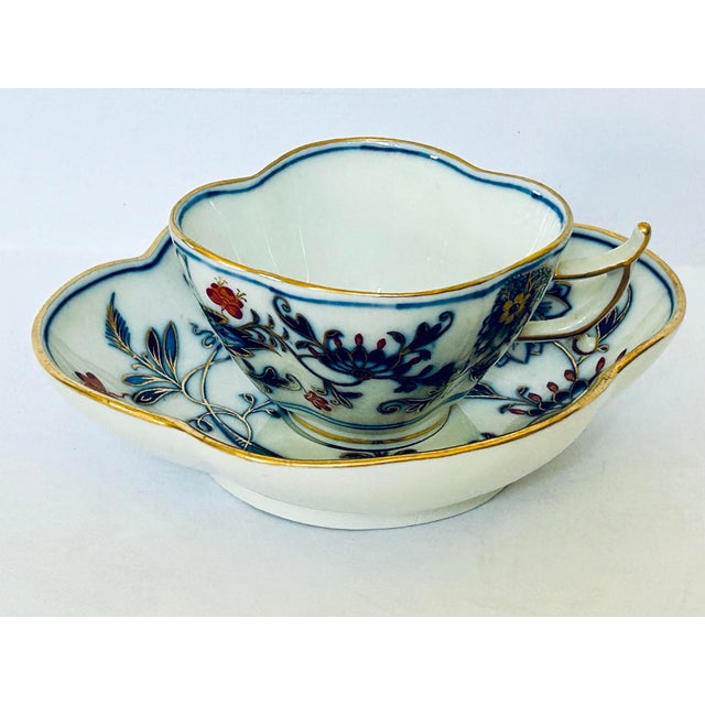 Meissen Blue Onion Red & Gold (Zwiebelmuster Rot & Gold) porcelain cup and saucer set featuring hand-painted blue, red,...