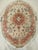 "A rare and exquisite vintage oval-shaped Persian Tabriz area rug from the late 19th century, featuring a delicate floral...