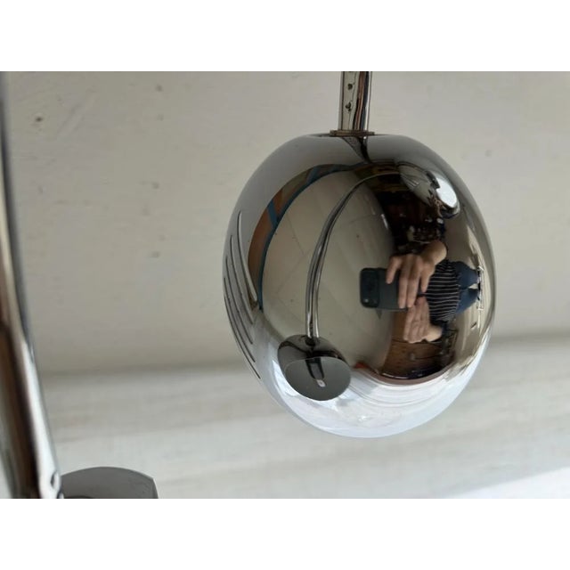 Five slender chrome arches fan out into the room from a heavy marble base. with a width of no less than 200 cm, this...