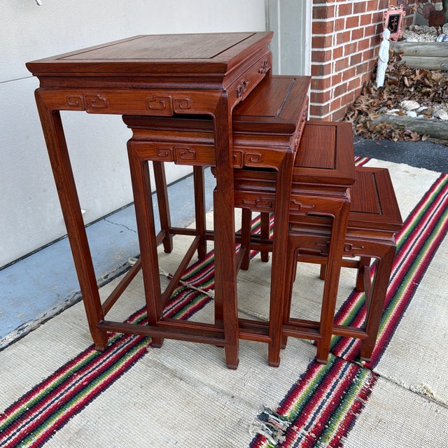 A Very Nice Set of 4 Vintage Chinoiserie Mahogany Nesting Tables, Circa 1960's Made in China, circa 1960's Chinoiserie...