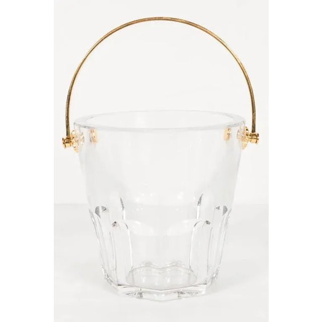 Ultra-luxe crystal ice pail with 24-karat gilt handle by Baccarat. Needed and stylized floral detailing and gold-plated...