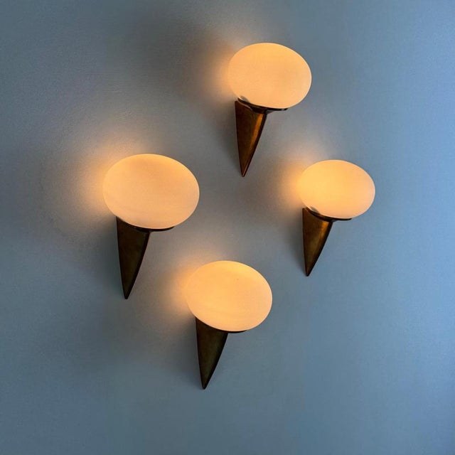 Refined and sculptural, this striking set of wall sconces — informally referred to as “lancia” for their resemblance to a...