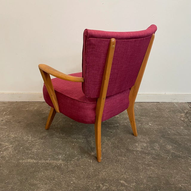 Mid-century modern arm chair attributed to Heywood Wakefield that has been reupholstered in a dark pink fabric. The pink...