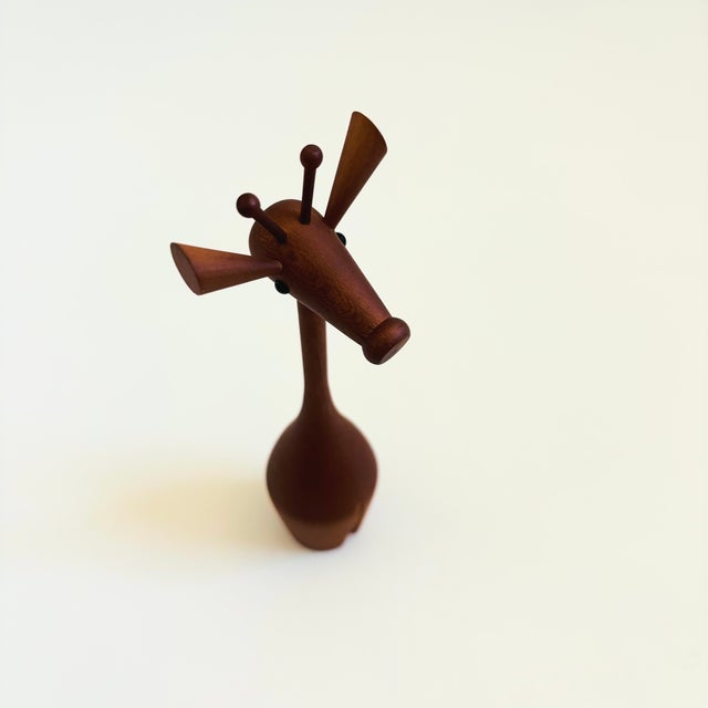 A mid century turned wood figurine in the shape of a giraffe. Adorable stylized features. Made in Japan by Senshukai as...
