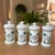 Spectacular set of 4 large porcelain apothecary jars with vivid hand painted palm tree and serpent decorations and Latin...