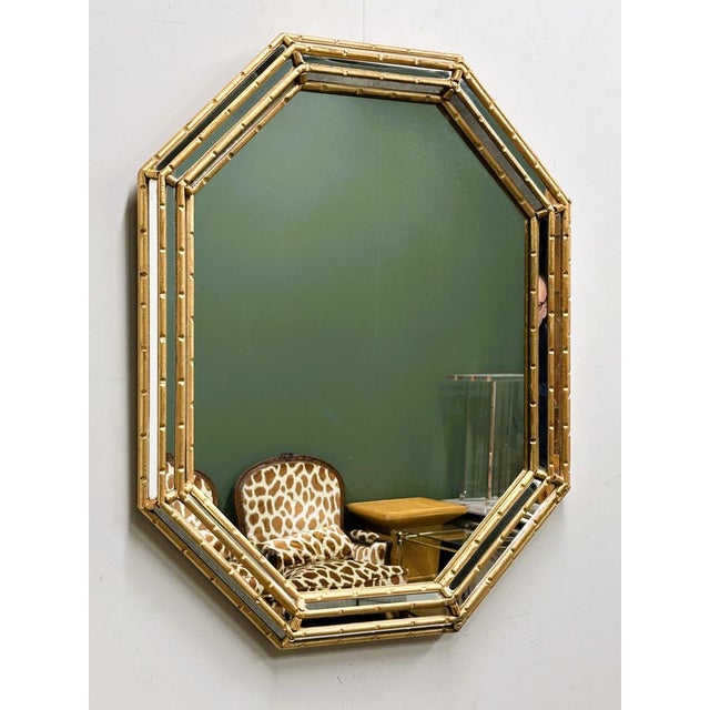 A striking 1980s faux-bamboo mirror with a warm gilt wooden frame and beautifully faceted mirrored panels. The octagonal...