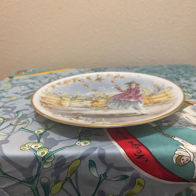 A charming vintage English bone china decorative display plate from the "Seasons of the Year" collection. This cabinet...
