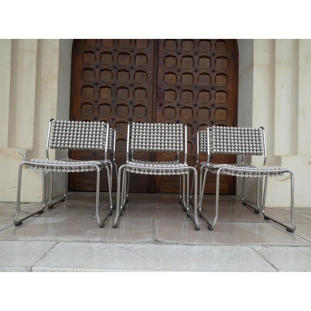 A generously sized, chromed tubular steel frame supports the light gray, flexible polyethylene elements, which are...