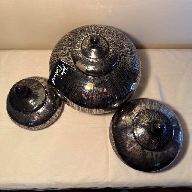 Make a dramatic statement with this graduated trio of contemporary lidded canisters by luxury home designer John-Richard....