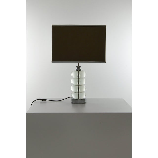 An Italian table lamp, most probably manufactured in the 1960s. The lamp consists of round crystal elements placed on a...