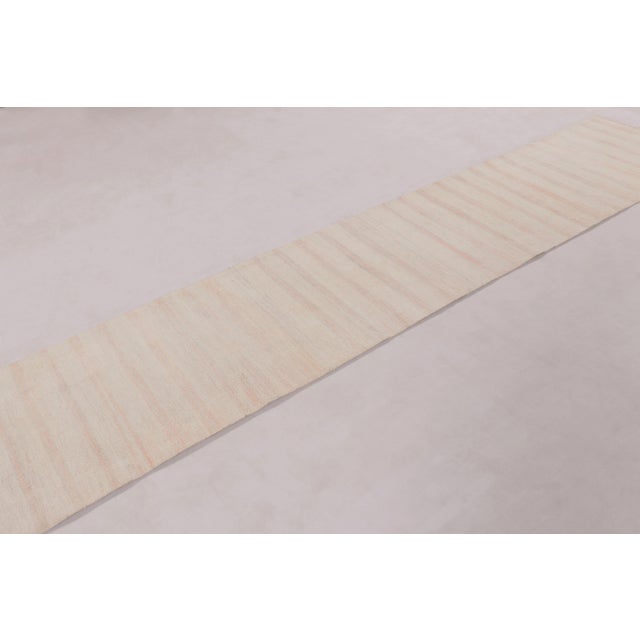 Handwoven in hemp circa 1950–1960, this 2x12 vintage Anatolian runner rug is a subtle and elegant example of mid-century...