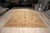 Peshawar rug in soft, sun washed colours. Large rust and terracotta palmettes and blossoms in the Oushak style are...