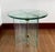 Beautiful 1970s side or end table by Leon Rosen for Pace. The table is round, primarily made of glass with brass hinges....
