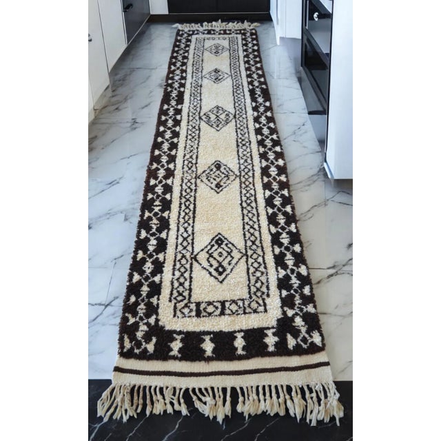 This mid-century Tulu runner, hand-knotted in the 1970s within the village homes of Southeast Anatolia, exemplifies the...