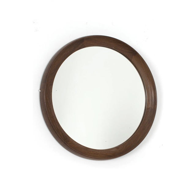Beautiful Danish round mirror with a teak wooden frame. The mirror contains some stains. Despite the traces of use, the...