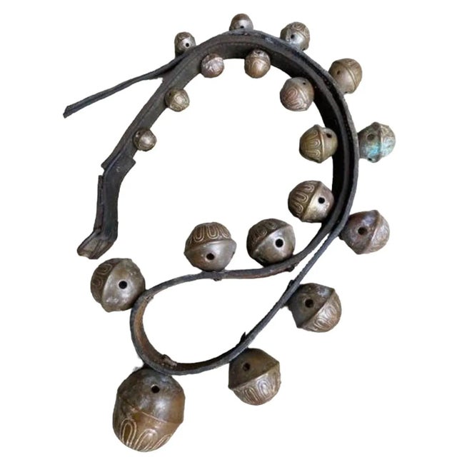 A set of numbered, graduated 1900s bronze sleigh bells on a leather strap with a melodic sound. Hang them outside your...