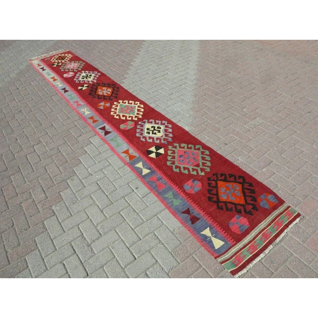 This beautiful, traditional vintage, flatweaved Turkish runner is approximately 60 years old. It is handmade of very fine...