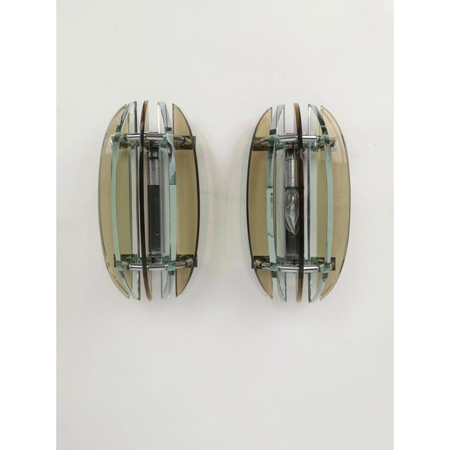A pair of wall sconces dating from the 60s and 70s and produced by the veca company, a famous italian company known for...