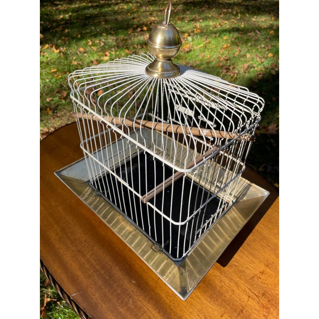 This fabulous Hendryx antique bird cage is highly collectible. It is made of brass and was manufactured by the Andrew B....