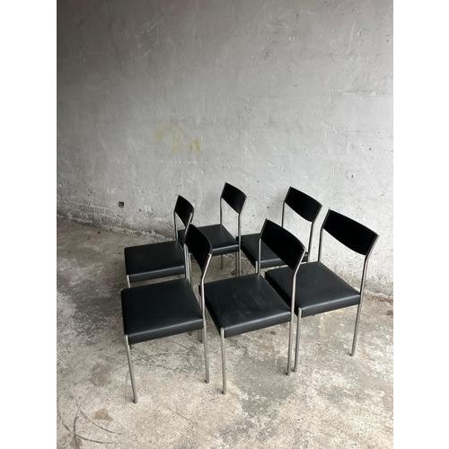 Introduction Elegant set of six mid-century dining chairs dating from the 1950s. These chairs feature black upholstered...