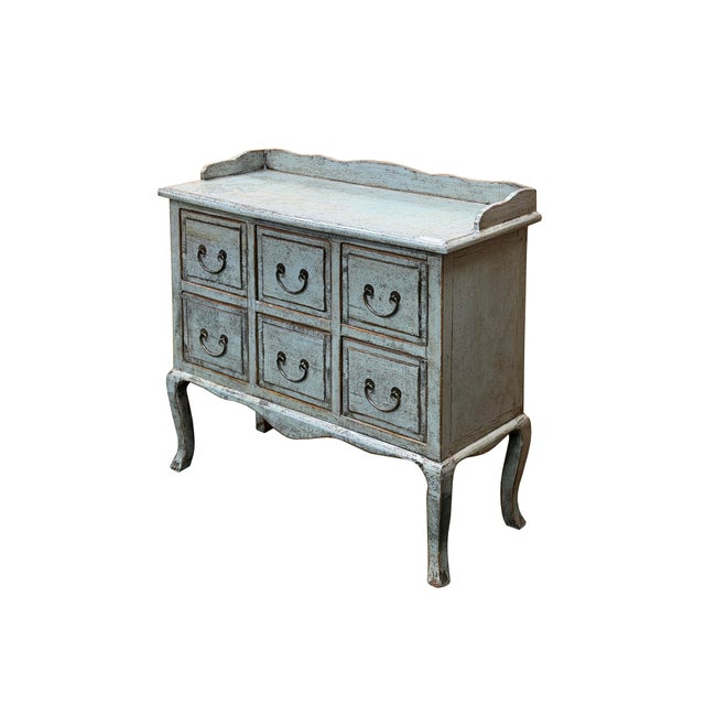 This charming antique-style dresser exudes rustic elegance with its weathered, pale blue green finish that hints at years...