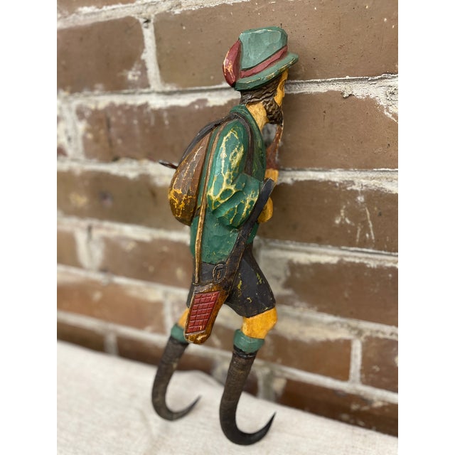 The Black Forest or Bavarian folk art whip holder is a hand painted bearded man with a pipe in his hand. He is carrying a...
