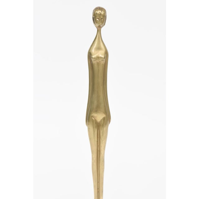 This vintage 1970's brass and black granite tall elongated female sculpture is arresting. it is not signed from what we...