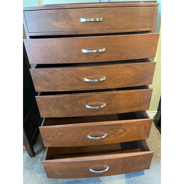 This solid cherry bow-front chest of drawers boasts chrome pulls and was built in PA. It includes six under-mount, soft-...