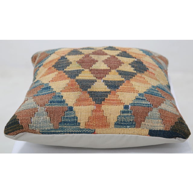 A one-of-a-kind handwoven Afghan wool kilim accent pillow featuring triangle diamond grid. Cut and sewn by hand from a...