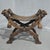 An outstanding Walnut X framed stool with a leather seat, carved lion heads holding steel rings with leather straps, lion...